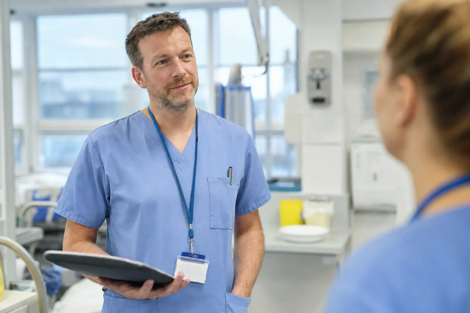 A man in his 40s working as a nurse after retraining for a new career