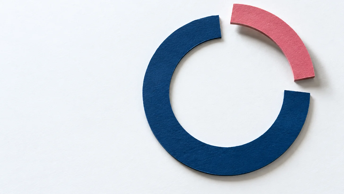 A thick cut-paper ring: two thirds closed in navy, the final third in coral lifted clear of the surface, representing the final year of a Bachelor's degree taken on its own.